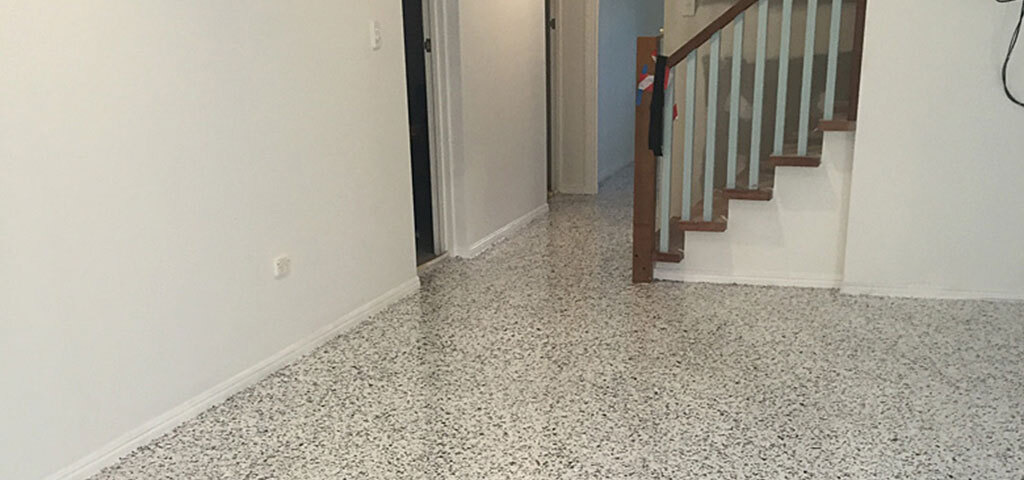 Flake epoxy floor in a home hallway by the stairs