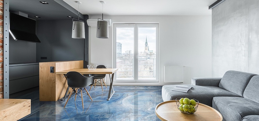 Living room with a blue metallic epoxy floor